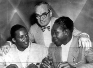 Gil Turner and Kid Gavilan flank promoter Herman Taylor